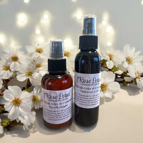 Brume ambiance et corps de 120 ml avec huiles aromatiques naturelles, affichée devant un fond de fleurs blanches.