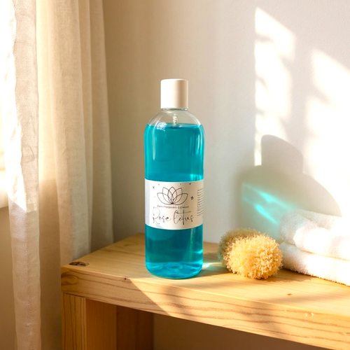 500ml bottle of blue hydrating foam bath gel on wooden surface with bath sponge and white towels nearby